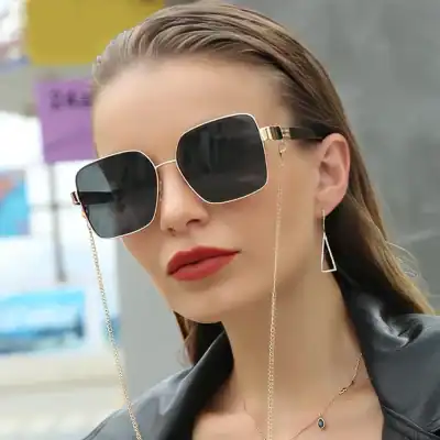 Stylish oversized square sunglasses with gold chain detail, perfect for eye protection and trendy look. Ideal for women seeking fashionable eyewear.