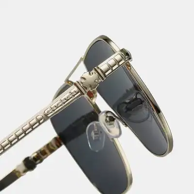 Stylish luxury sunglasses featuring gold-toned details and tinted lenses, perfect for fashion-forward individuals seeking high-end eyewear at Monalisa Store.