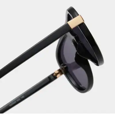 High-quality black sunglasses with gold details, perfect for UV protection and fashion statement. Ideal for outdoor activities, providing both style and eye safety.