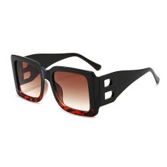 Stylish black and red-accented oversized sunglasses with gradient lenses, perfect for sun protection and fashion-forward look. High-quality materials and iconic design by Monalisa Store.
