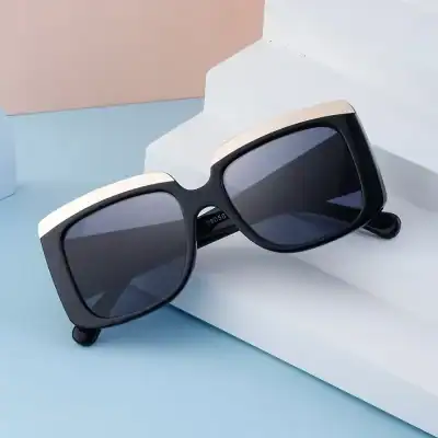 Stylish black and white sunglasses with dark lenses, perfect for UV protection and everyday fashion. Ideal for men and women looking for trendy, durable eyewear.