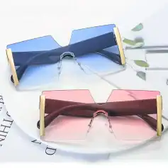 Stylish oversized fashion sunglasses with tinted lenses in blue and pink, featuring gold accents for a trendy look perfect for summer and outdoor activities.
