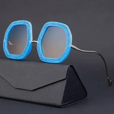 Blue sunglasses with embossed frames, tinted lenses, and sleek design, ideal for fashion-forward individuals seeking UV protection and a trendy look.