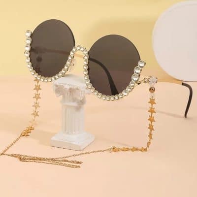 Fashionable sunglasses featuring a star-shaped beaded chain perfect for trendy accessory looks.