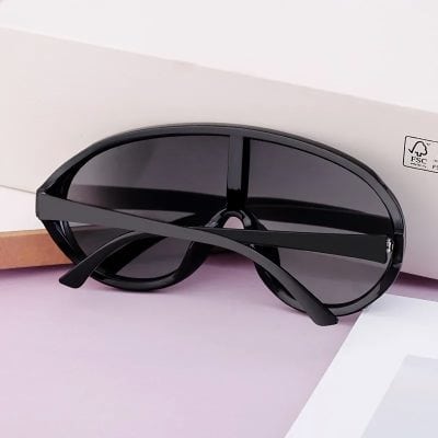 Stylish black sunglasses with dark lenses and sleek design, perfect for eye protection and modern fashion. Ideal for outdoor wear and UV shielding.