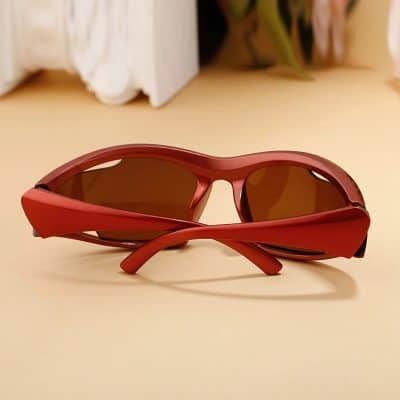 Stylish red sunglasses featuring wraparound design and polarized lenses for optimal eye protection and UV filtering, perfect for casual and outdoor fashion.