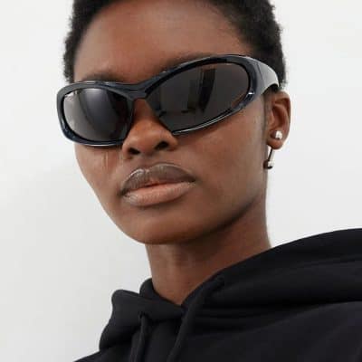 Elegant black designer sunglasses on woman with dark skin, showcasing the latest fashion trend in eyewear from Monalisa Store. Perfect for sun protection and stylish accessorizing.