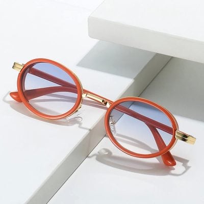 Stylish round sunglasses with orange frames and blue tinted lenses, perfect for all-day wear and UV protection. Ideal for fashion-forward individuals seeking eye health and sun protection.