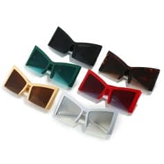 Stylish, oversized sunglasses with bold frames in various colors including black, green, tortoise shell, red, beige, and white, perfect for trendy eyewear shoppers.