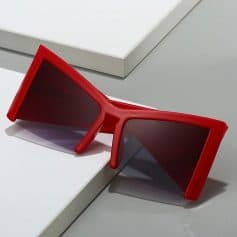 Stylish red sunglasses with dark lenses, perfect for UV protection and enhancing your fashion statement at Monalisa Store.
