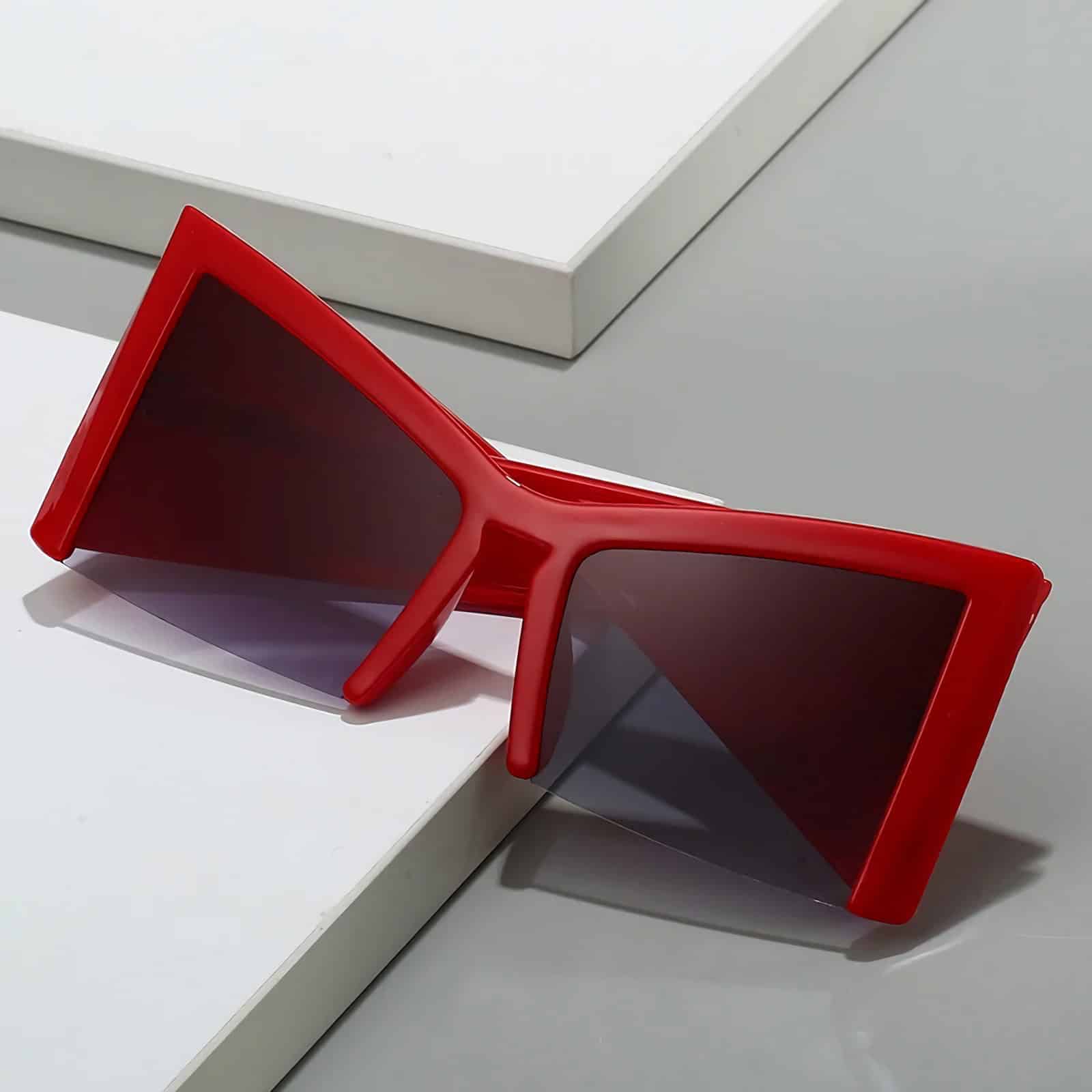 Stylish red sunglasses with dark lenses, perfect for UV protection and enhancing your fashion statement at Monalisa Store.