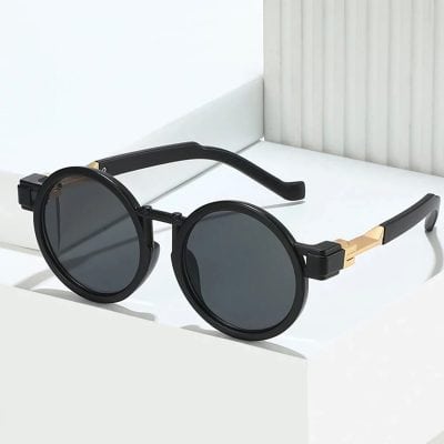 Black round sunglasses with tinted lenses and gold accents, perfect for summer fashion, UV protection, and sun protection, available at Monalisa Medical Store.
