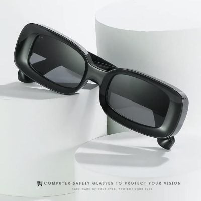 Stylish black safety glasses with tinted lenses designed for digital device users, ideal for protecting eyes from blue light and screen glare in modern office or home environments.