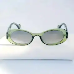 Stylish green and black sunglasses with oval tinted lenses, perfect for UV protection and outdoor activities, available at Monalisa Medical's Monalisa Store.