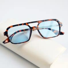 Stylish tortoise shell optical glasses with blue tinted lenses, perfect for versatile fashion and eye protection. Ideal for everyday wear and enhancing your look.