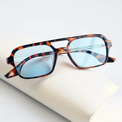 Stylish tortoise shell optical glasses with blue tinted lenses, perfect for versatile fashion and eye protection. Ideal for everyday wear and enhancing your look.