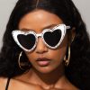 Stylish white heart-shaped sunglasses with rhinestone accents, perfect for women seeking trendy and unique eyewear. Ideal for fashion, sun protection, and making a statement.