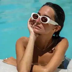 Bold white sunglasses for summer fashion and eye protection against UV rays. Perfect for poolside or beach days, offering a stylish and comfortable look.