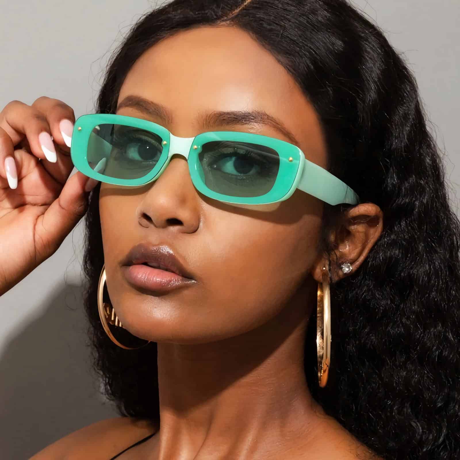 Stylish turquoise sunglasses with green-tinted lenses for UV protection and fashion-forward look. Perfect accessory for sunny days and trendy outfits.