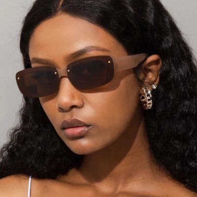 Women’s fashionable sunglasses with dark lenses, transparent frame, and elegant accessories, offering UV protection and enhancing trendy look.