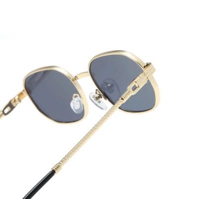 High-quality stylish sunglasses with dark lenses and gold frames, perfect for fashion and UV protection. Comfortable fit with adjustable nose pads and sturdy temples.