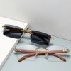 Fashionable designer sunglasses with dark tinted lenses, gold detailing, and stylish frames designed for UV protection and enhancing your outdoor look.