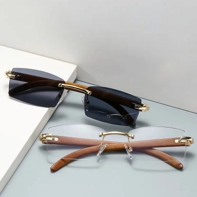Fashionable designer sunglasses with dark tinted lenses, gold detailing, and stylish frames designed for UV protection and enhancing your outdoor look.