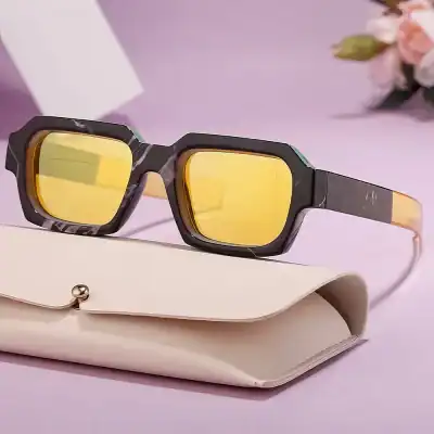 Stylish black and gold sunglasses with mirrored yellow lenses for eye protection and fashion. Perfect for everyday wear and outdoor activities.