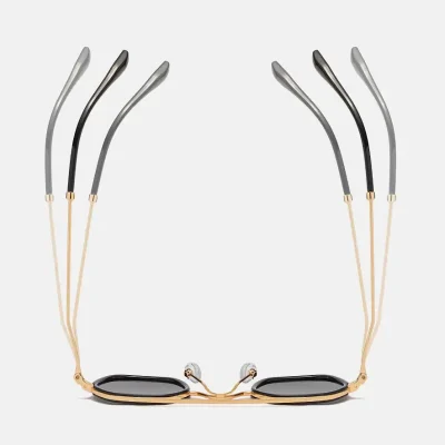 Stylish black and gold framed sunglasses with adjustable temples and tinted lenses for UV protection, perfect for fashion and eye health.