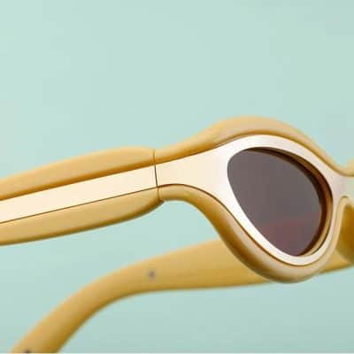 Sunglasses with yellow frames and black tinted lenses, ideal for sun protection and style. Available at Monalisa Store for optical and eyewear needs.