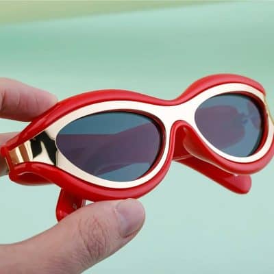 Stylish red and white retro sunglasses with tinted lenses, perfect for sun protection and fashion. Unique design ideal for all ages, blending vintage style with modern trends.