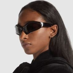 Close-up of stylish black sunglasses on a woman with dark hair, emphasizing modern eyewear for fashion and eye protection. Perfect for trendy accessories and statement sunglasses.