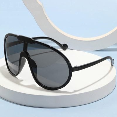 Stylish black sunglasses with dark lenses, perfect for protecting your eyes from the sun and adding a trendy touch to your summer outfit. Ideal for outdoor activities and daily wear.