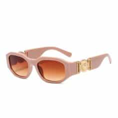 Pink sunglasses with gradient lenses and gold logo accents, perfect for sun protection and fashion.