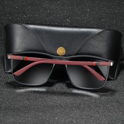 Stylish black sunglasses with red textured arms on black case.