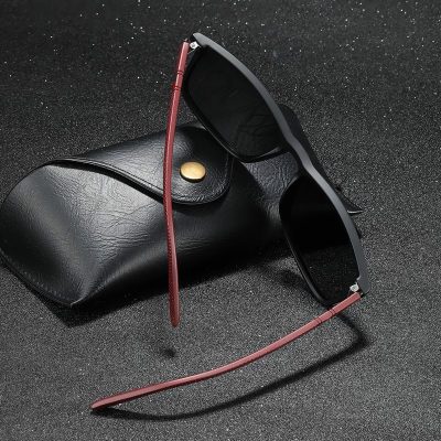 Stylish black sunglasses with red temples, perfect for UV protection and everyday wear. Ideal for fashion-conscious individuals seeking quality eyewear.