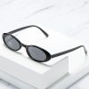 Fashionable black sunglasses with oval frames and tinted lenses for eye protection and style.