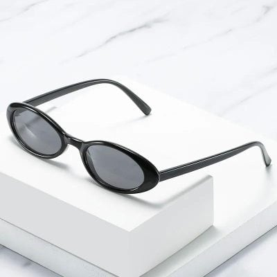 Fashionable black sunglasses with oval frames and tinted lenses for eye protection and style.