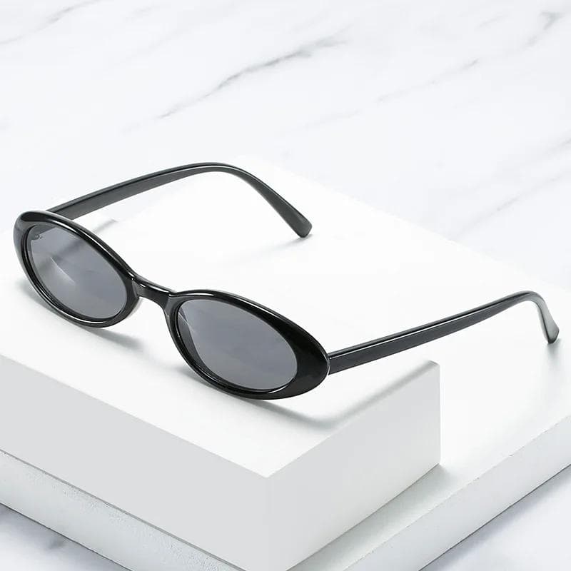 Stylish black sunglasses with oval lenses, perfect for UV protection and fashion statements. Great for everyday wear and outdoor activities. Enhance your look with these trendy shades.