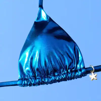 Vibrant blue bikini top made from shiny, metallic fabric, perfect for summer beachwear or poolside fashion, featuring a star-shaped charm for stylish detail.