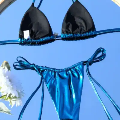 Elegant blue satin bikini with adjustable ties and black scalloped edges, ideal for swimwear and beach fashion.
