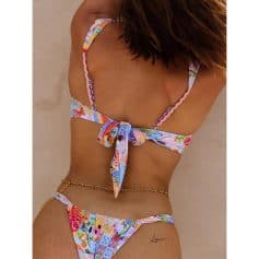 Bright floral tropical swimsuit with bow detail.