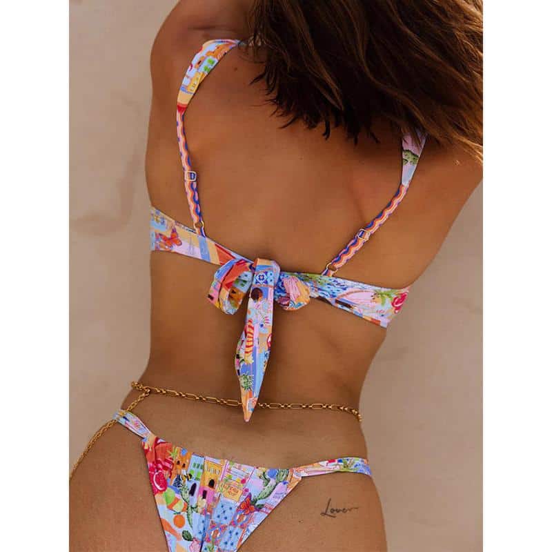 Bright floral tropical swimsuit with bow detail.