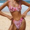 A woman wearing a floral bikini on the beach, showcasing swimwear styles and summer fashion trends. Perfect for beach vacations, poolside lounging, and tropical getaways.