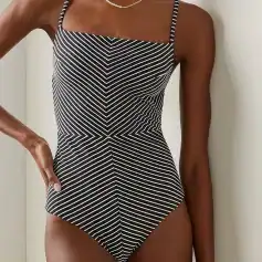 A stylish black and white striped one-piece swimsuit with adjustable spaghetti straps, perfect for summer beach days and poolside lounging.