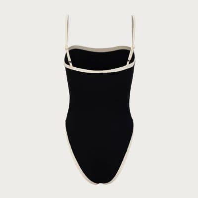Stylish black and white one-piece swimsuit ideal for swimming and beach wear. Comfortable fit with adjustable shoulder straps and elegant design. Perfect for summer ocean adventures or poolside lounging.