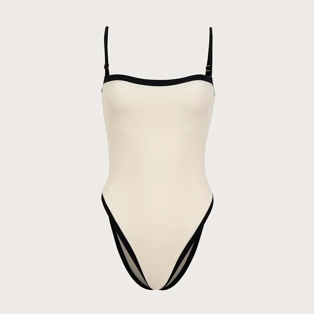 Stylish women's fashion body suit for casual or dressy wear, featuring a sleek white design with black accents, perfect for modern fashion statements.