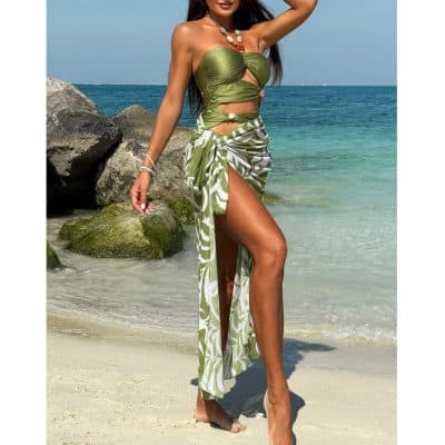 A stylish women’s summer beach outfit featuring a green crop top and matching wrap skirt with a high slit, perfect for tropical vacations and beach outings.
