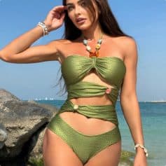Stunning green bikini swimsuit with cut-out design, perfect for beach or poolside fashion. Made from high-quality, textured fabric emphasizing style and comfort.