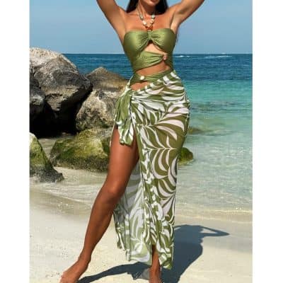 Stylish tropical beachwear with cutout design and leaf print, perfect for summer vacation and beach outings. Comfortable, trendy, and sexy swim cover-up for women.